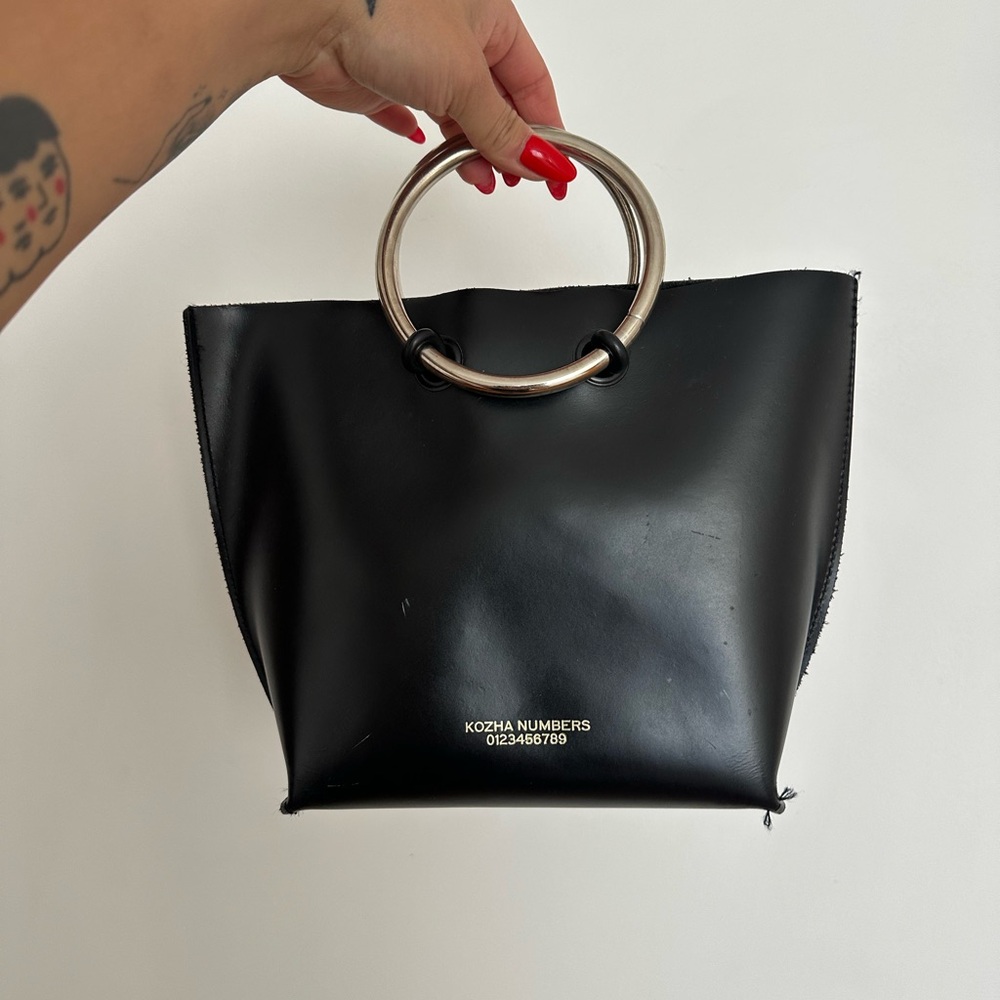 Black leather Kozha Numbers bag with silver ring handle